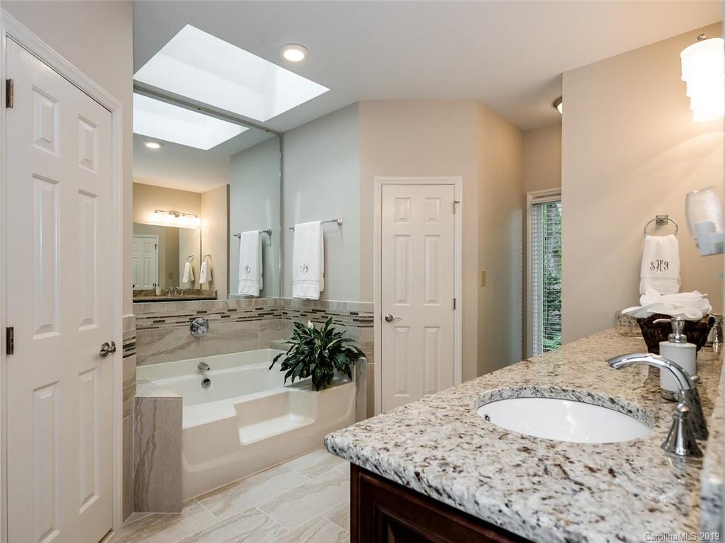 5123 Randolph Road Charlotte, NC 28211 - Photo 16 of 28 a bath room with a granite countertop sink and a mirror