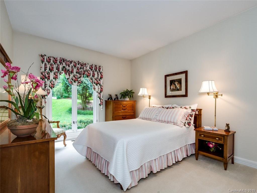 5123 Randolph Road Charlotte, NC 28211 - Photo 17 of 28 a bedroom with a balcony a bed and a couch