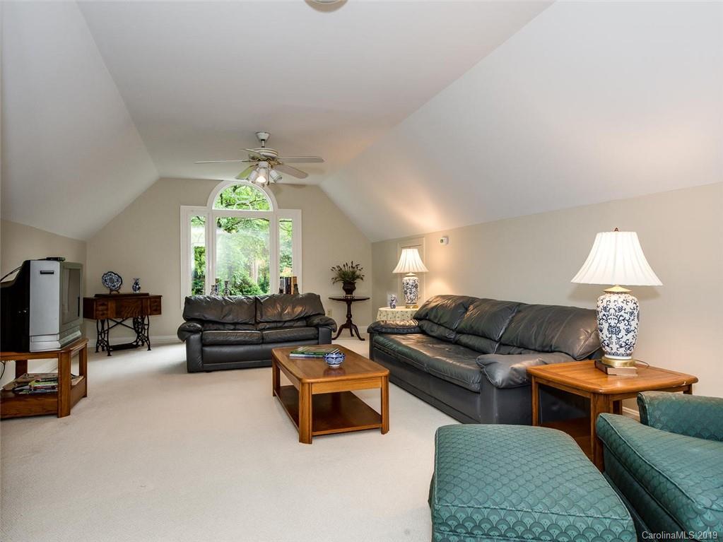 5123 Randolph Road Charlotte, NC 28211 - Photo 20 of 28 a living room with furniture and a chandelier