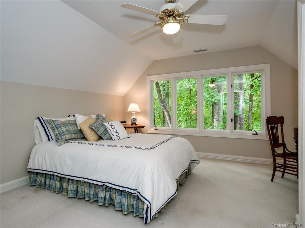 5123 Randolph Road Charlotte, NC 28211 - Photo 21 of 28 a spacious bedroom with a bed and a large window