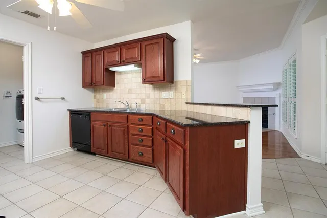a kitchen with stainless steel appliances granite countertop a stove and a refrigerator