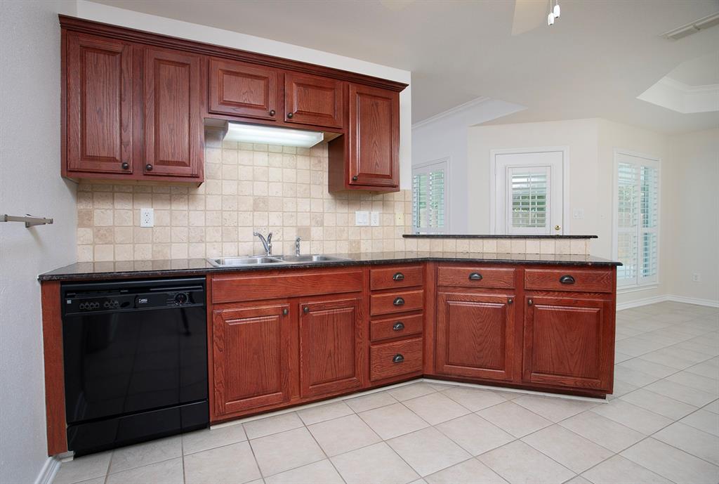 1521 Rice Road, Unit E105 Tyler, TX 75703 - Photo 14 of 29 a kitchen with granite countertop a sink dishwasher stove and cabinets