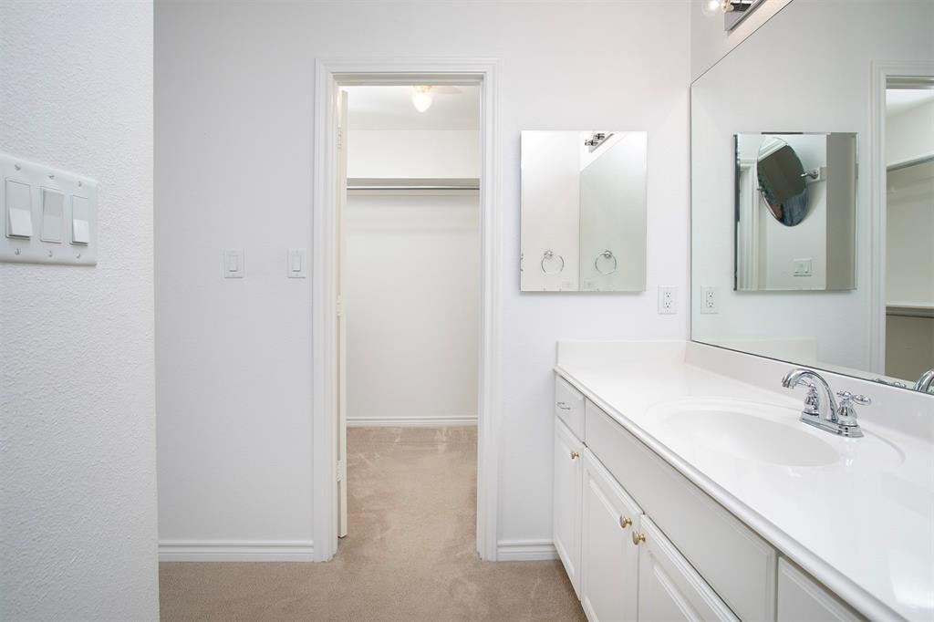 1521 Rice Road, Unit E105 Tyler, TX 75703 - Photo 17 of 29 a bathroom with a sink and a mirror