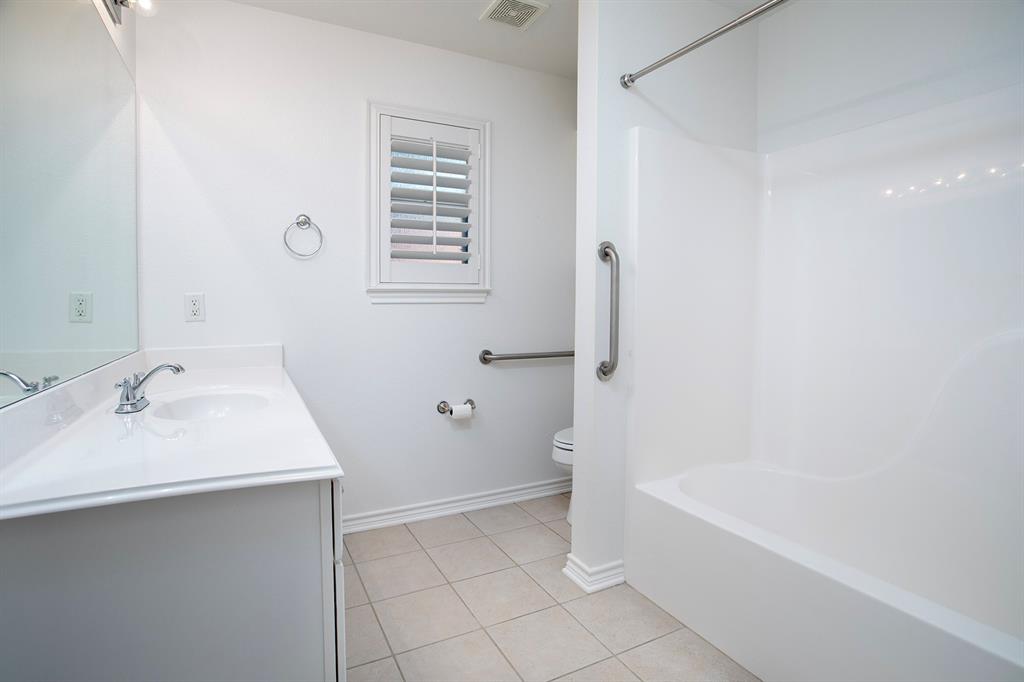 1521 Rice Road, Unit E105 Tyler, TX 75703 - Photo 22 of 29 a bathroom with a sink a bathtub and a shower