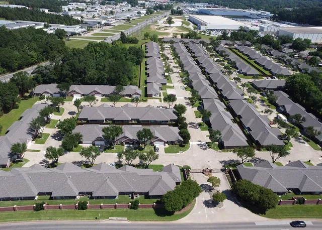 an aerial view of multiple houses with yard