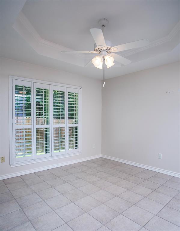 1521 Rice Road, Unit E105 Tyler, TX 75703 - Photo 9 of 29 a view of an empty room with a window