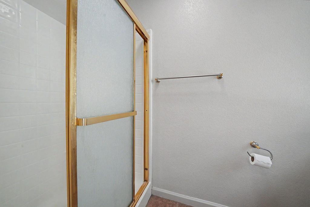 26845 Spring Court Pioneer, CA 95666 - Photo 39 of 89 a bathroom with a glass shower door