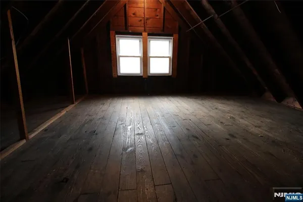 a view of wooden floor and windows in a room