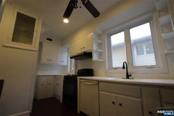 a kitchen with a sink cabinets and window