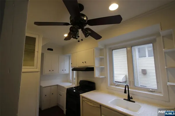 a kitchen with a sink stainless steel appliances and cabinets