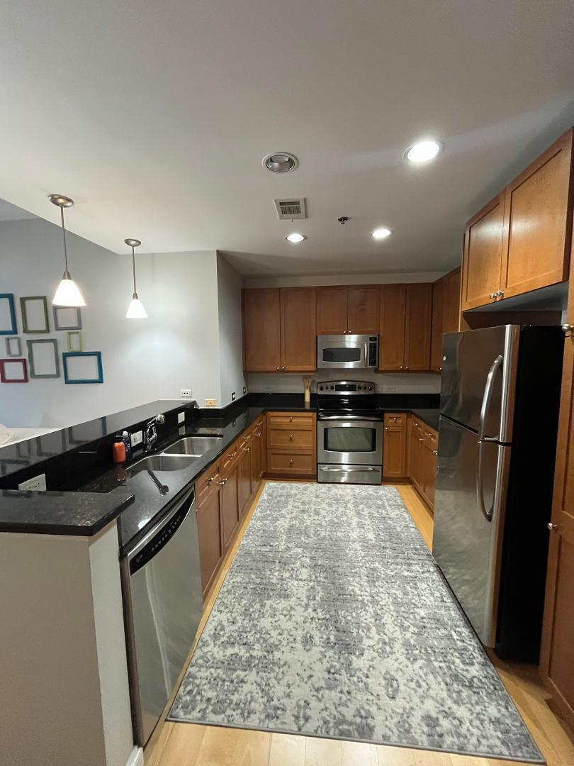 618 North Boylan Avenue Raleigh, NC 27603 - Photo 3 of 15 a kitchen with stainless steel appliances granite countertop a sink stove and refrigerator