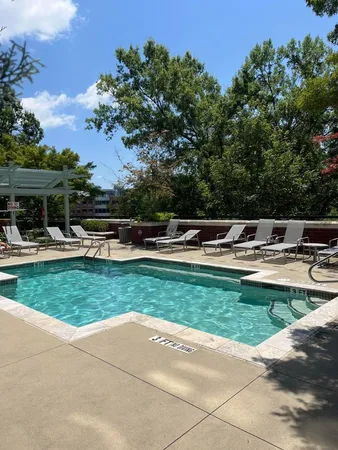 a view of a swimming pool with a yard