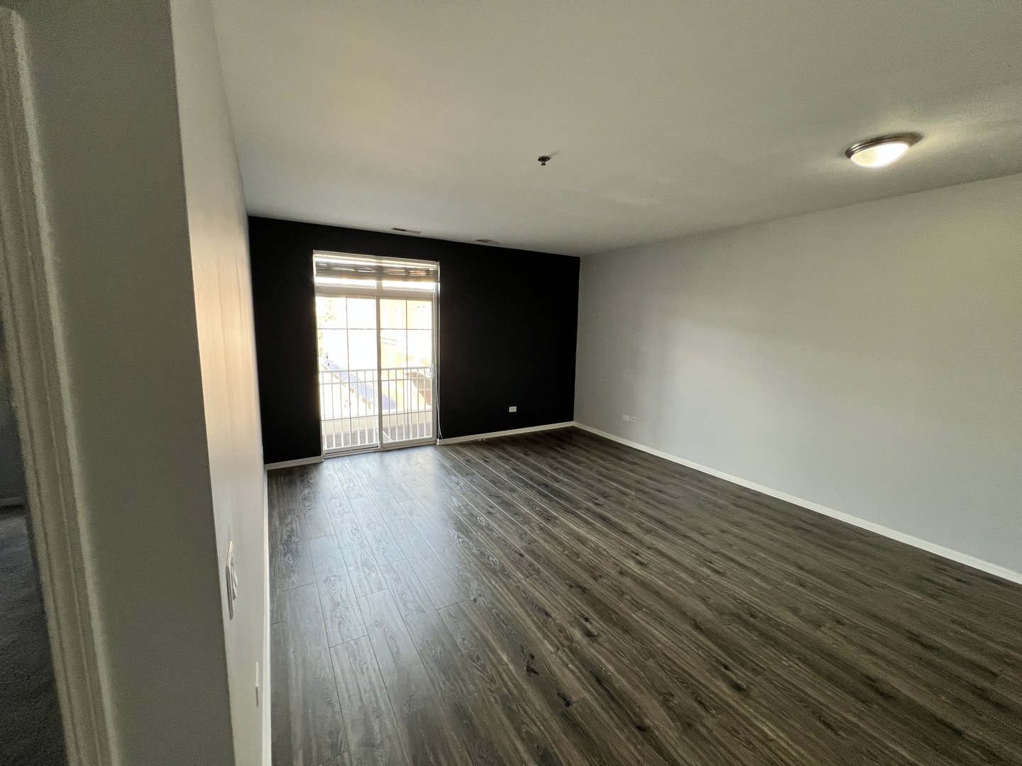 625 Deerfield Road, Unit 317 Deerfield, IL 60015 - Photo 6 of 9 a view of an empty room with wooden floor and a window