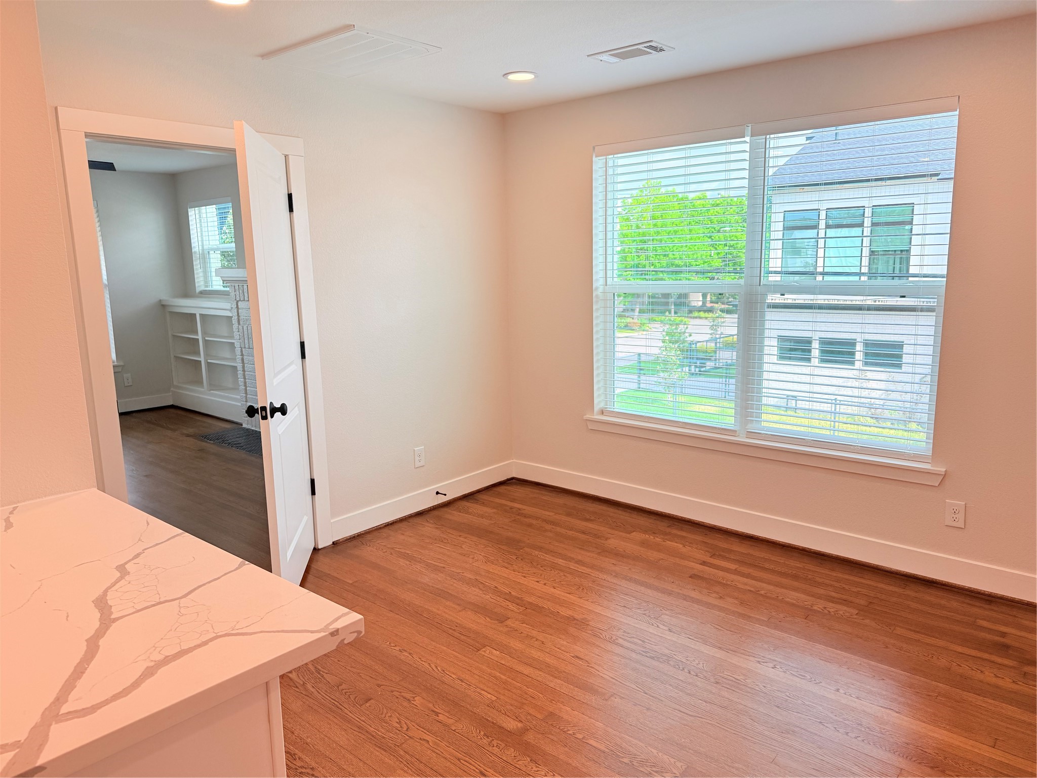 2001 Brun Street, Unit 1 Houston, TX 77019 - Photo 4 of 15 an empty room with wooden floor and windows