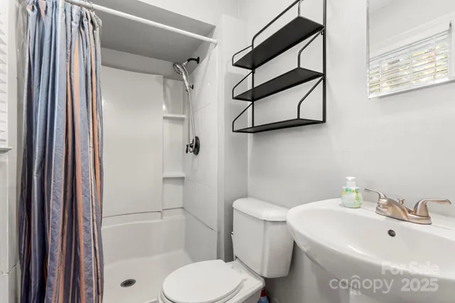 a white toilet sitting next to a bathroom sink