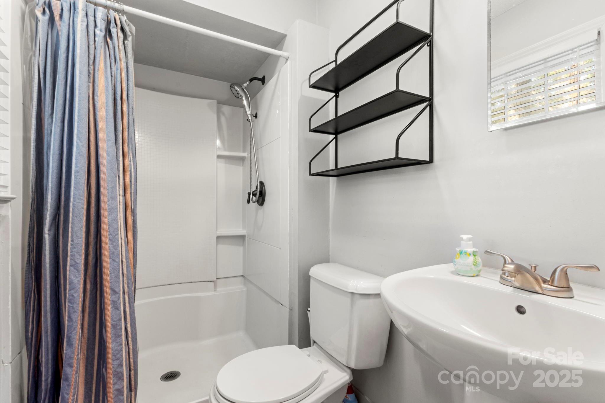 893 Ragin Lane Rock Hill, SC 29732 - Photo 21 of 29 a white toilet sitting next to a bathroom sink