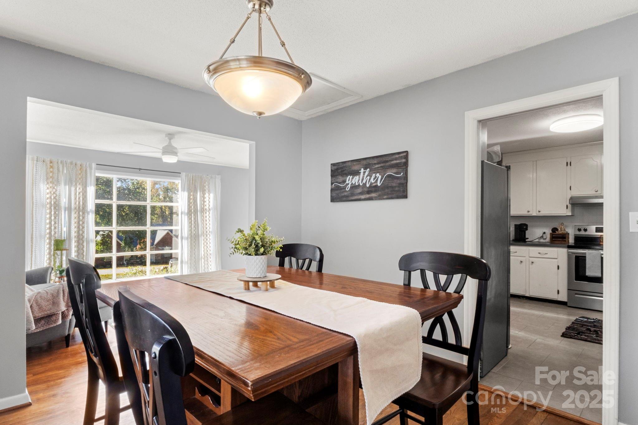 893 Ragin Lane Rock Hill, SC 29732 - Photo 6 of 29 a view of a dining room and livingroom with furniture window and wooden floor