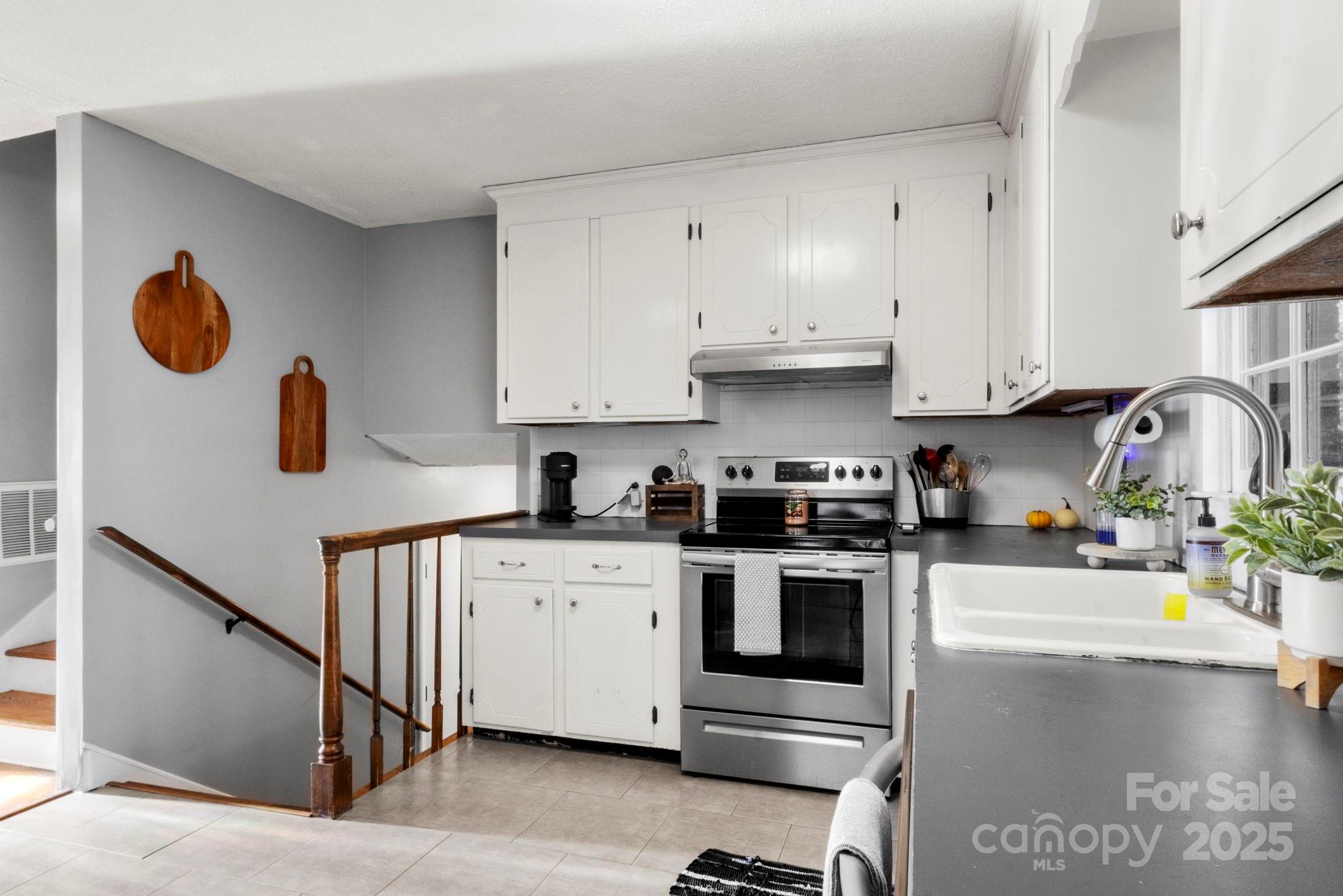 893 Ragin Lane Rock Hill, SC 29732 - Photo 7 of 29 a kitchen with stainless steel appliances granite countertop a sink stove and cabinets