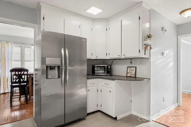 a kitchen with stainless steel appliances granite countertop a refrigerator a stove and a refrigerator
