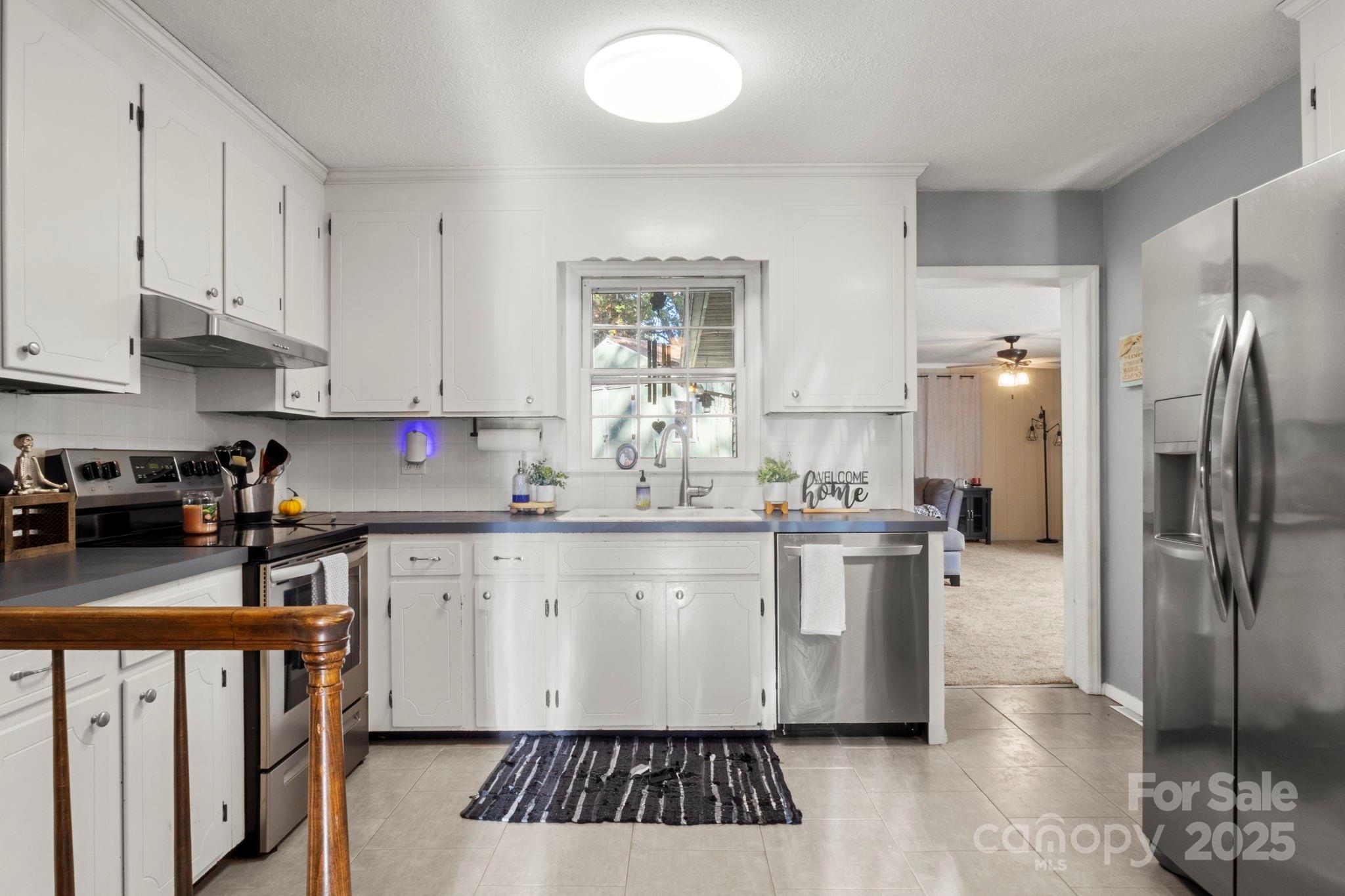 893 Ragin Lane Rock Hill, SC 29732 - Photo 10 of 29 a kitchen with stainless steel appliances granite countertop a sink stove and refrigerator