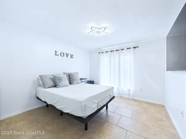 a spacious bedroom with a bed and a table