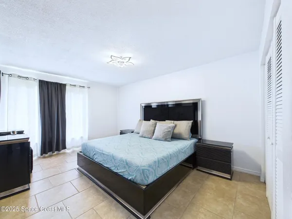 a bedroom with a bed and a night stand