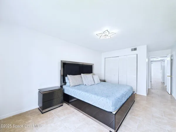 a bedroom with a bed and a night stand