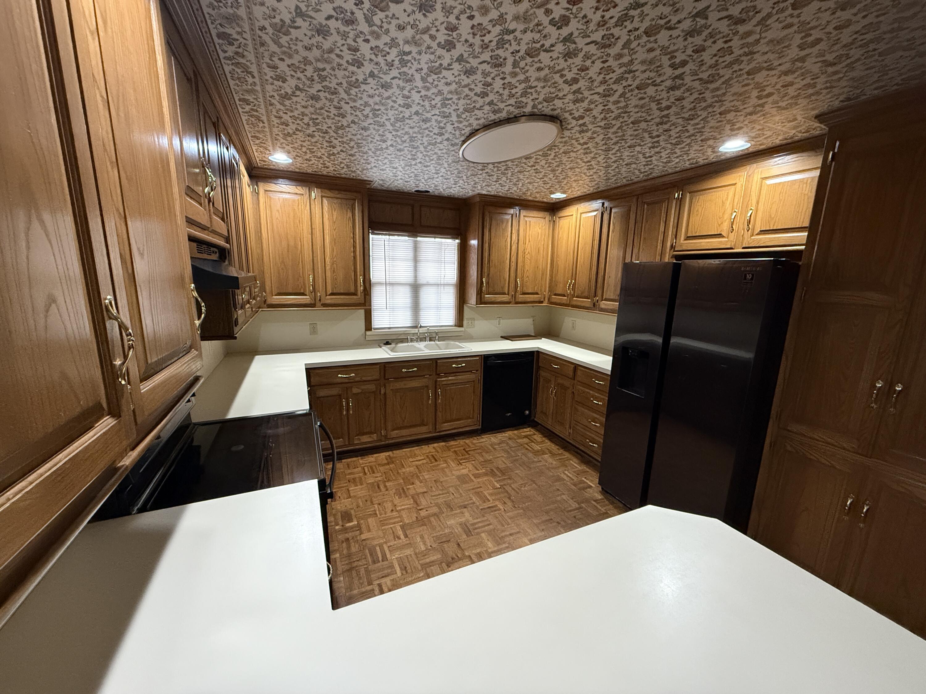 4828 11th Street Lubbock, TX 79416 - Photo 3 of 12 a large kitchen with a sink and large window