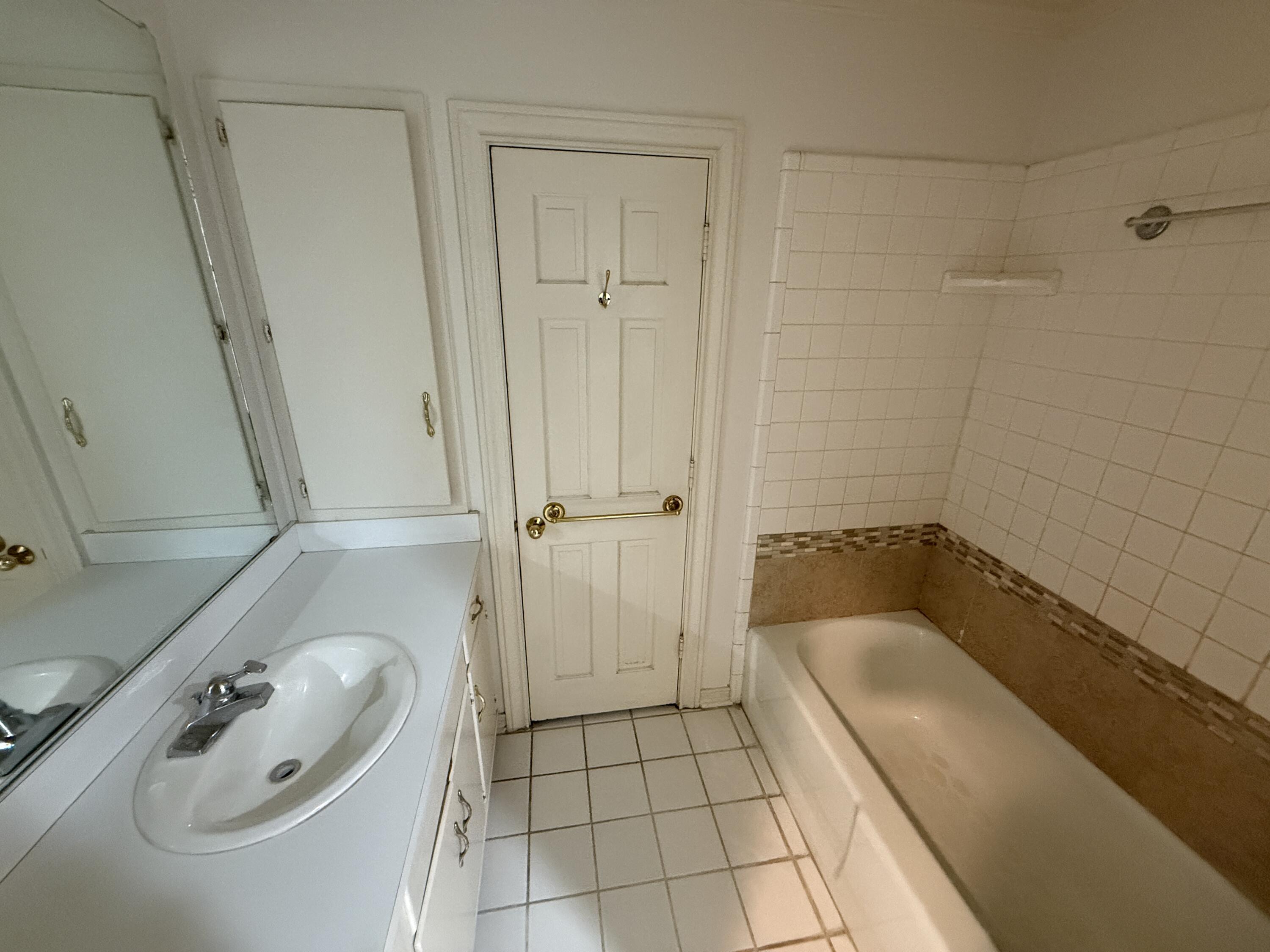 4828 11th Street Lubbock, TX 79416 - Photo 7 of 12 a bathroom with a granite countertop sink a toilet and shower