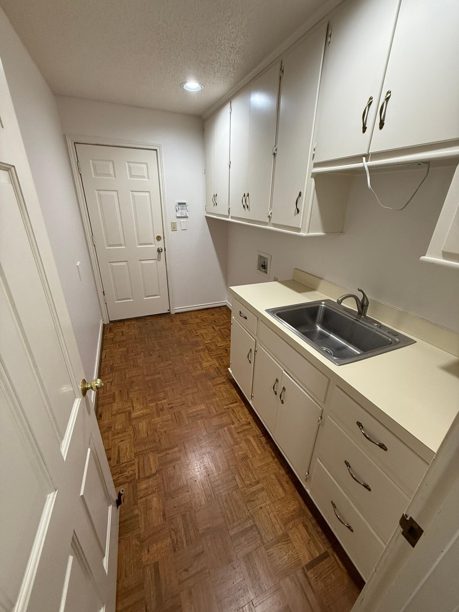 4828 11th Street Lubbock, TX 79416 - Photo 8 of 12 a kitchen with stainless steel appliances granite countertop a sink and cabinets