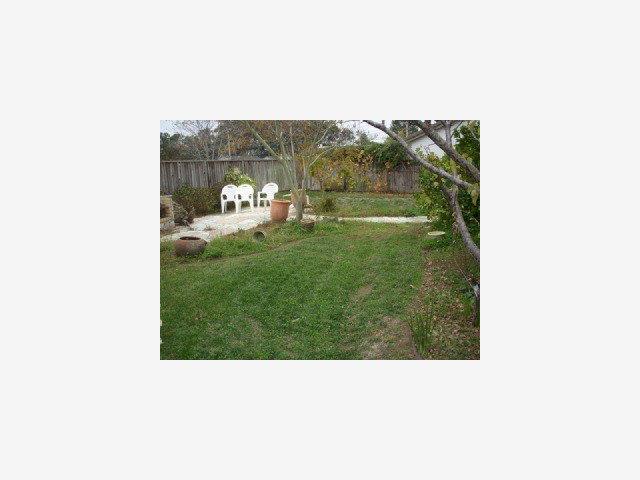 3308 Axford Road Santa Cruz, CA 95062 - Photo 9 of 9 a picture of a bench in middle of a garden