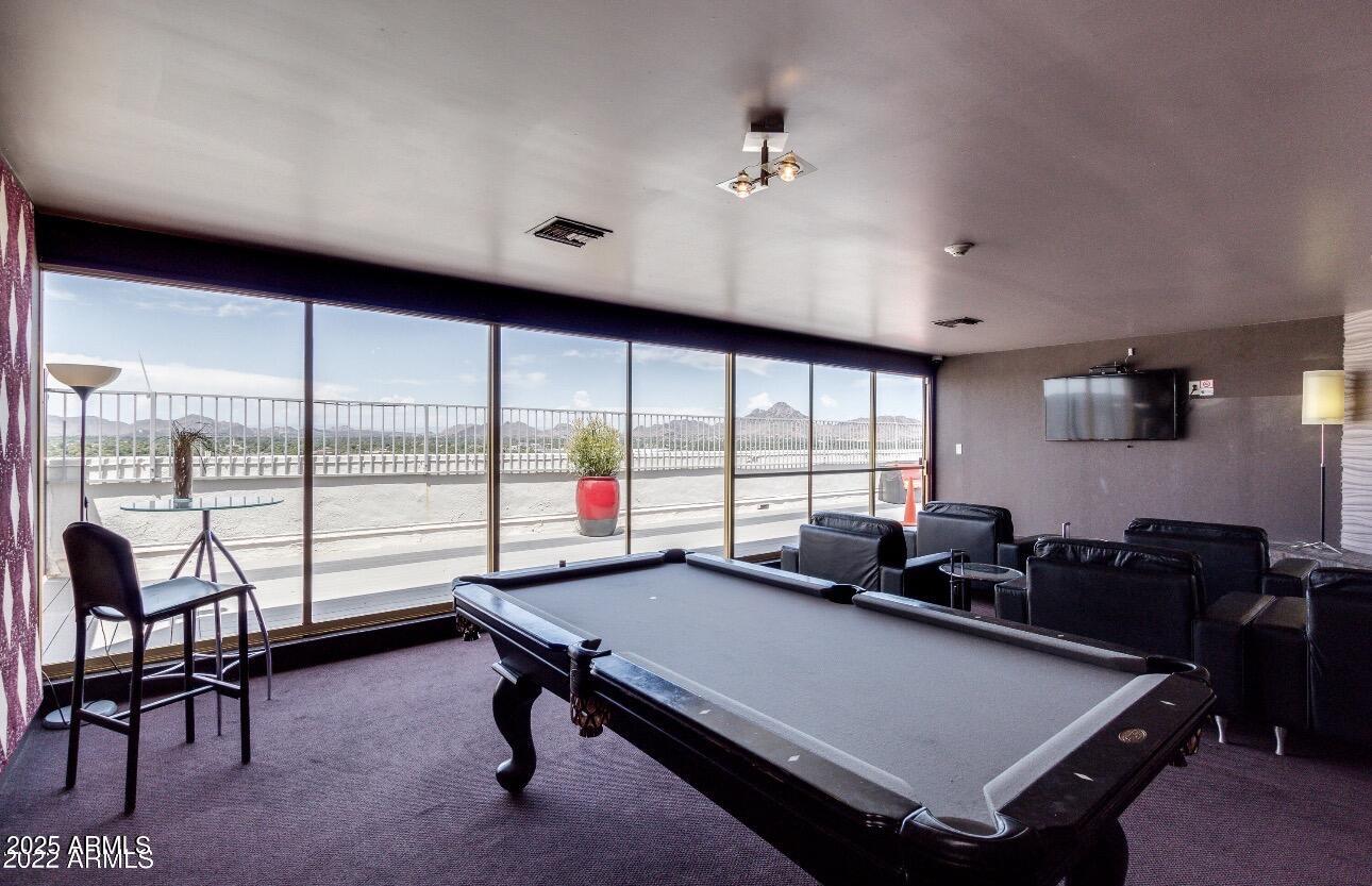 4750 North Central Avenue, Unit 3A Phoenix, AZ 85012 - Photo 20 of 24 a living room with furniture a rug and a large window