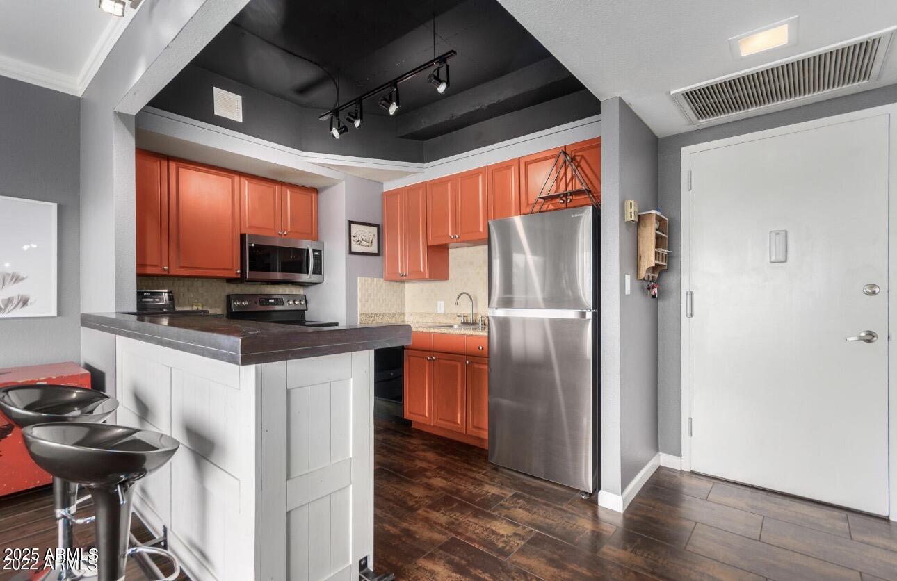 4750 North Central Avenue, Unit 3A Phoenix, AZ 85012 - Photo 4 of 24 a kitchen with stainless steel appliances granite countertop a refrigerator and a stove top oven