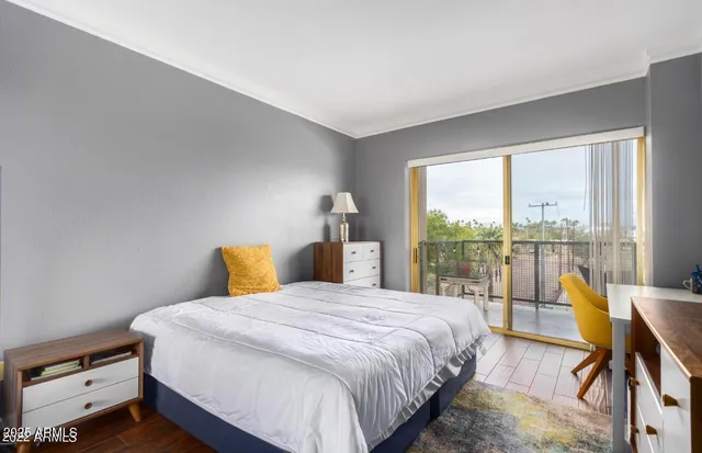 a bedroom with a bed and a large window