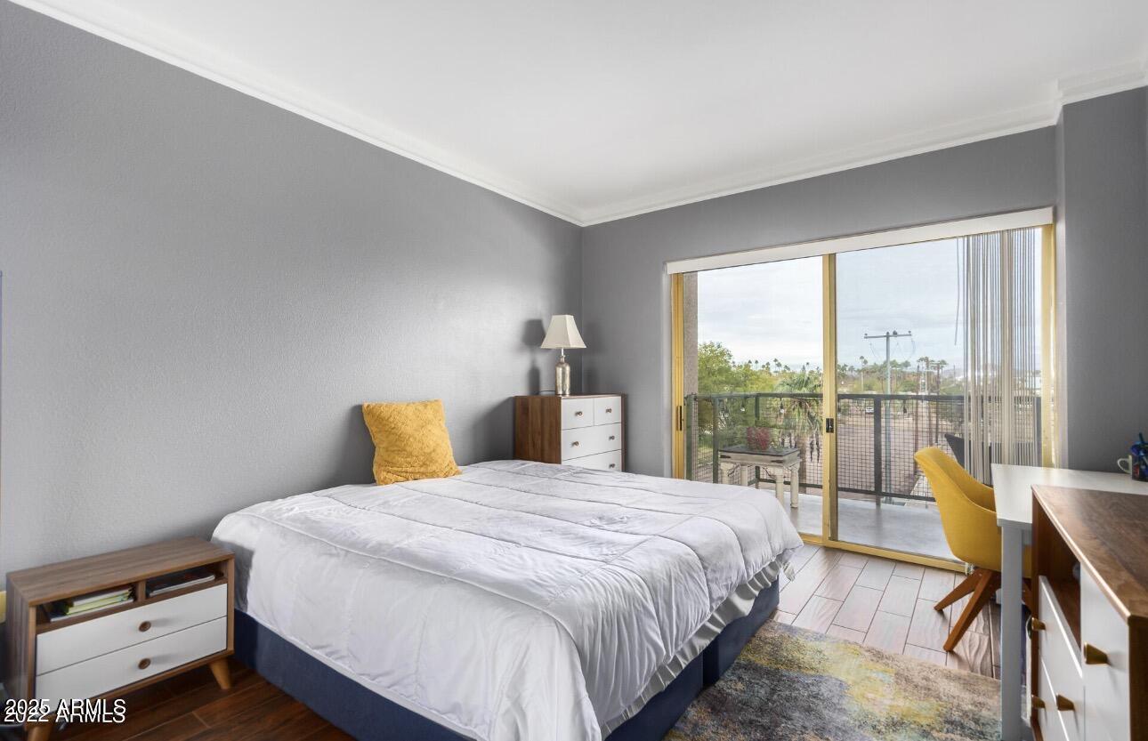 4750 North Central Avenue, Unit 3A Phoenix, AZ 85012 - Photo 8 of 24 a bedroom with a bed and a large window