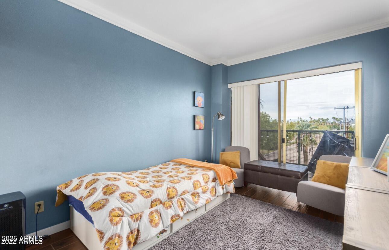 4750 North Central Avenue, Unit 3A Phoenix, AZ 85012 - Photo 9 of 24 a bedroom with a bed and a couch next to a window