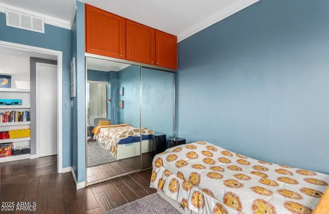 a bedroom with natural light and wooden floor