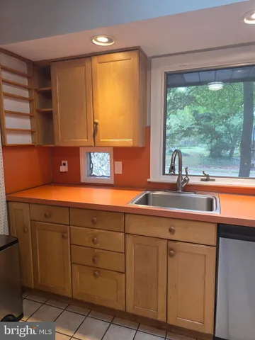 a kitchen with a sink and large window