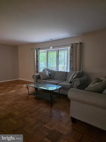 a living room with furniture a window and a table