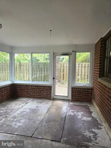 an empty room with wooden floor and furniture