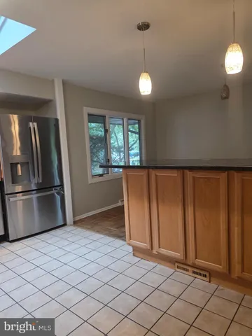 a view of a refrigerator in kitchen and wooden floor