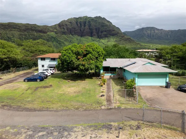 a view of a house with pool and a yard