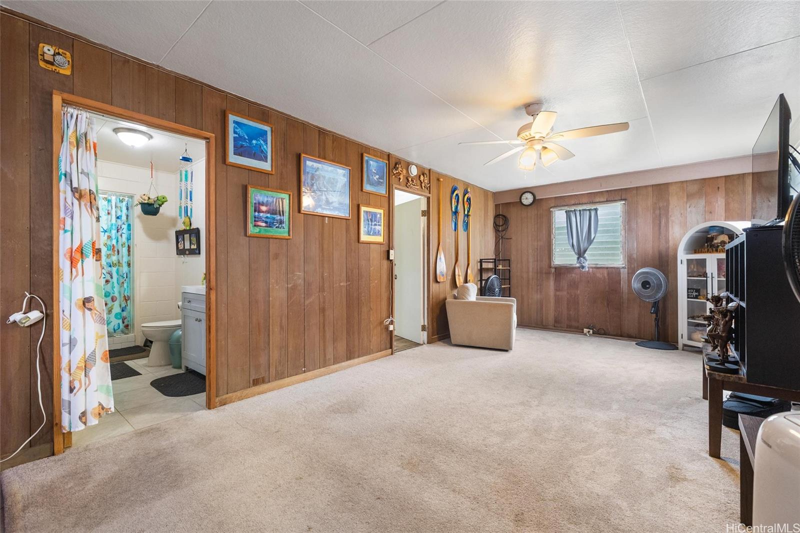85-576 Waianae Valley Road, Unit A Waianae, HI 96792 - Photo 9 of 20 This living room is located downstairs of the 2-story home. View of bathroom and door to the laundry room