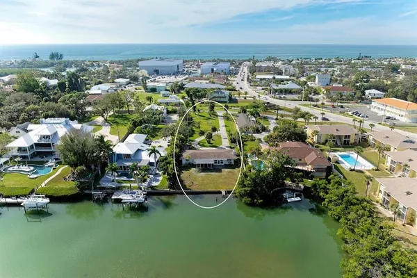 an aerial view of a house with a garden and lake view