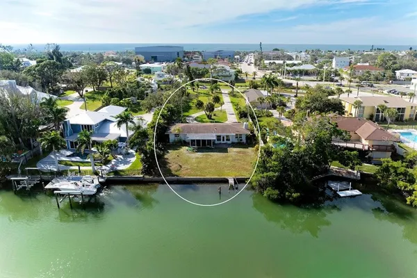 an aerial view of a house with a garden and lake view