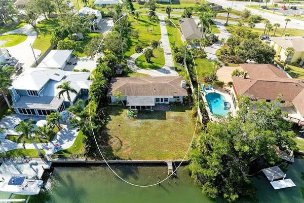 an aerial view of residential houses with outdoor space and swimming pool
