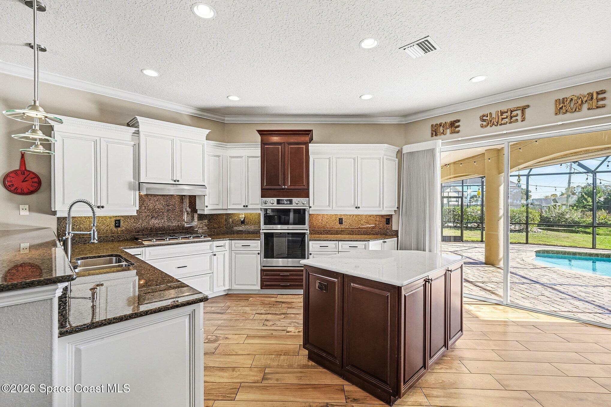 1 Point View Place Cocoa, FL 32926 - Photo 12 of 45 a large kitchen with kitchen island a large counter top space a sink stainless steel appliances and cabinets