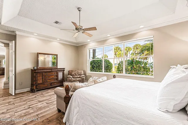 a bedroom with a bed couch and a window