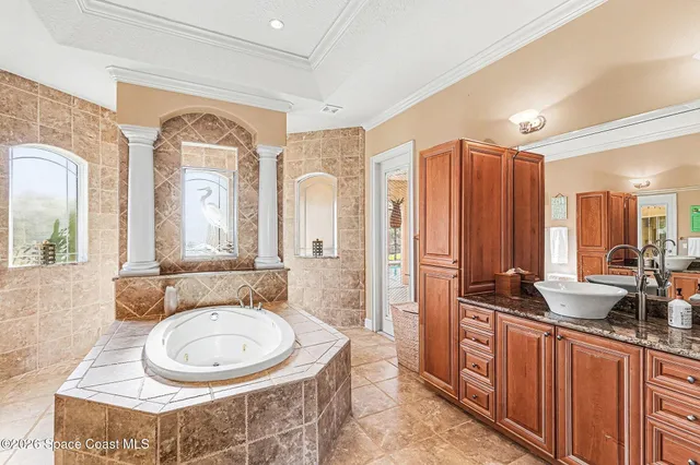 a spacious bathroom with a double vanity sink a mirror a window and a shower