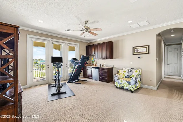 a living room with furniture a flat screen tv and a floor to ceiling window